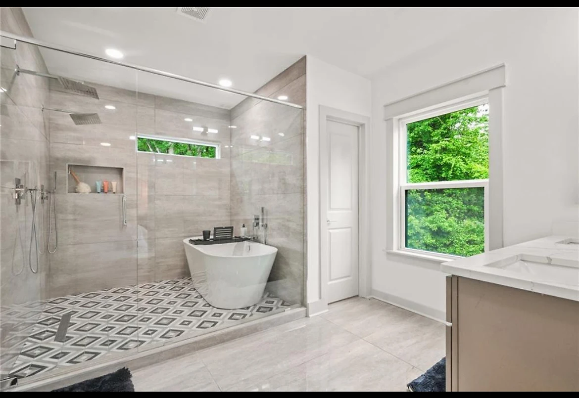 Owner's bath with a freestanding tub and walk-in rain shower