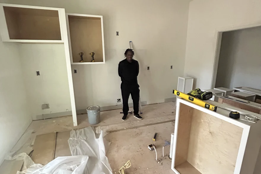 Interior fit-out underway with cabinet boxes set and floors still protected